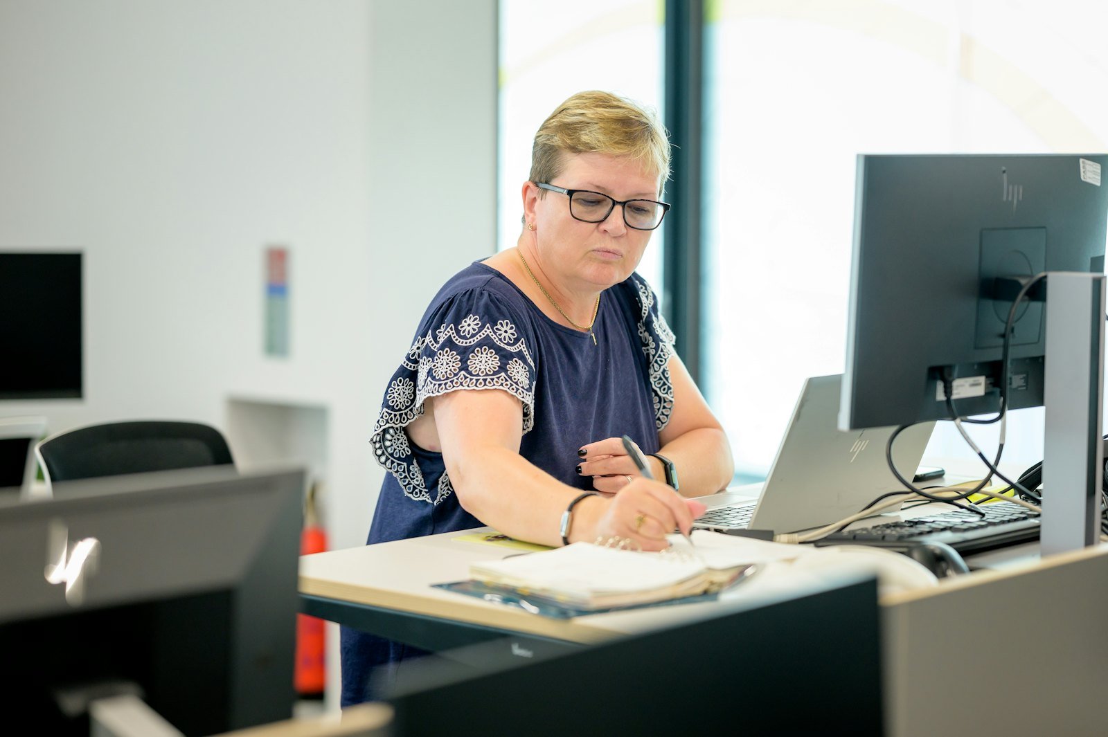 An accountant reviewing financial figures at a desk for a client